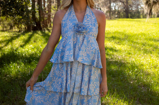Blue floral halter dress with layered design and rose detail, perfect for summer outings.