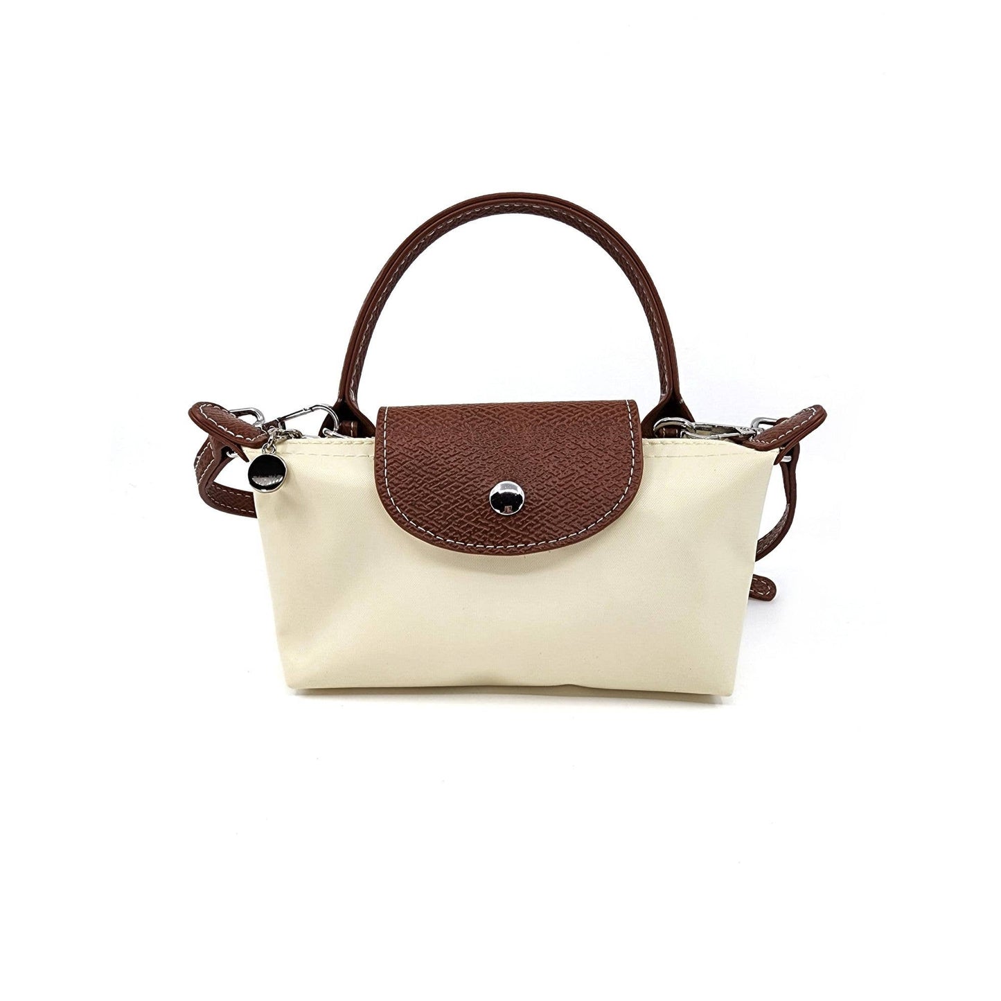 Small beige handbag with brown handle and flap on a white background