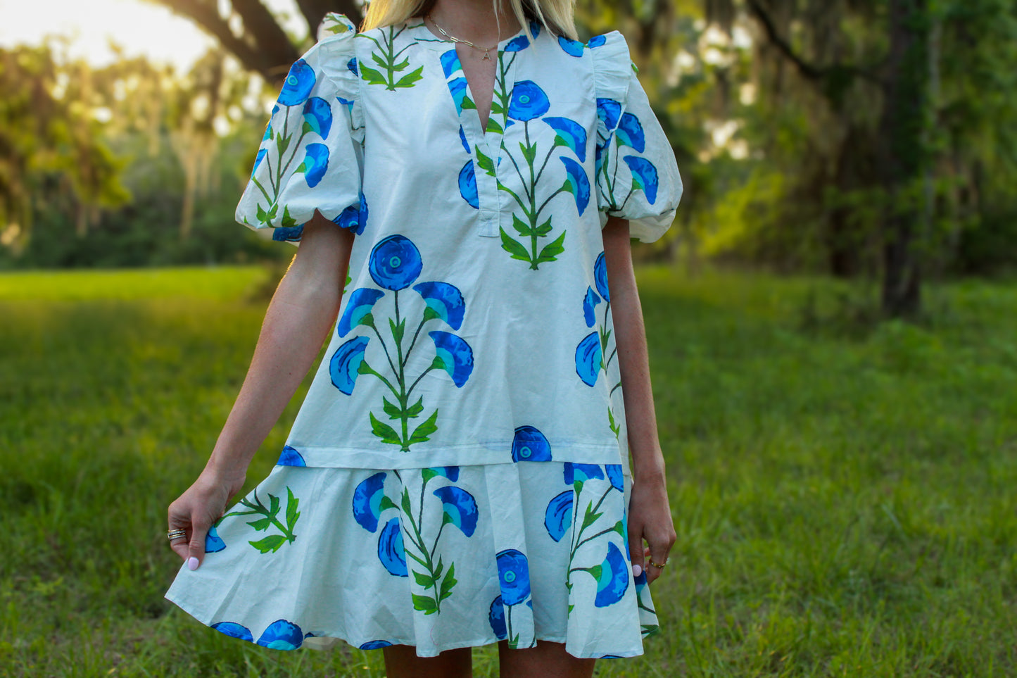 Floral print dress with blue flowers, puff sleeves, and a tiered hem, perfect for casual summer outings.
