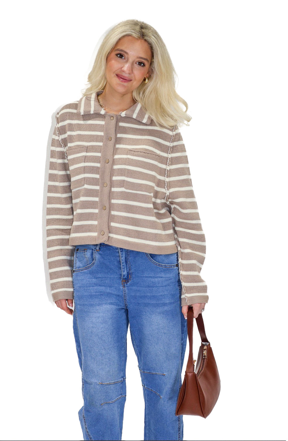 Woman wearing a striped shirt and blue jeans holding a brown bag on a white background