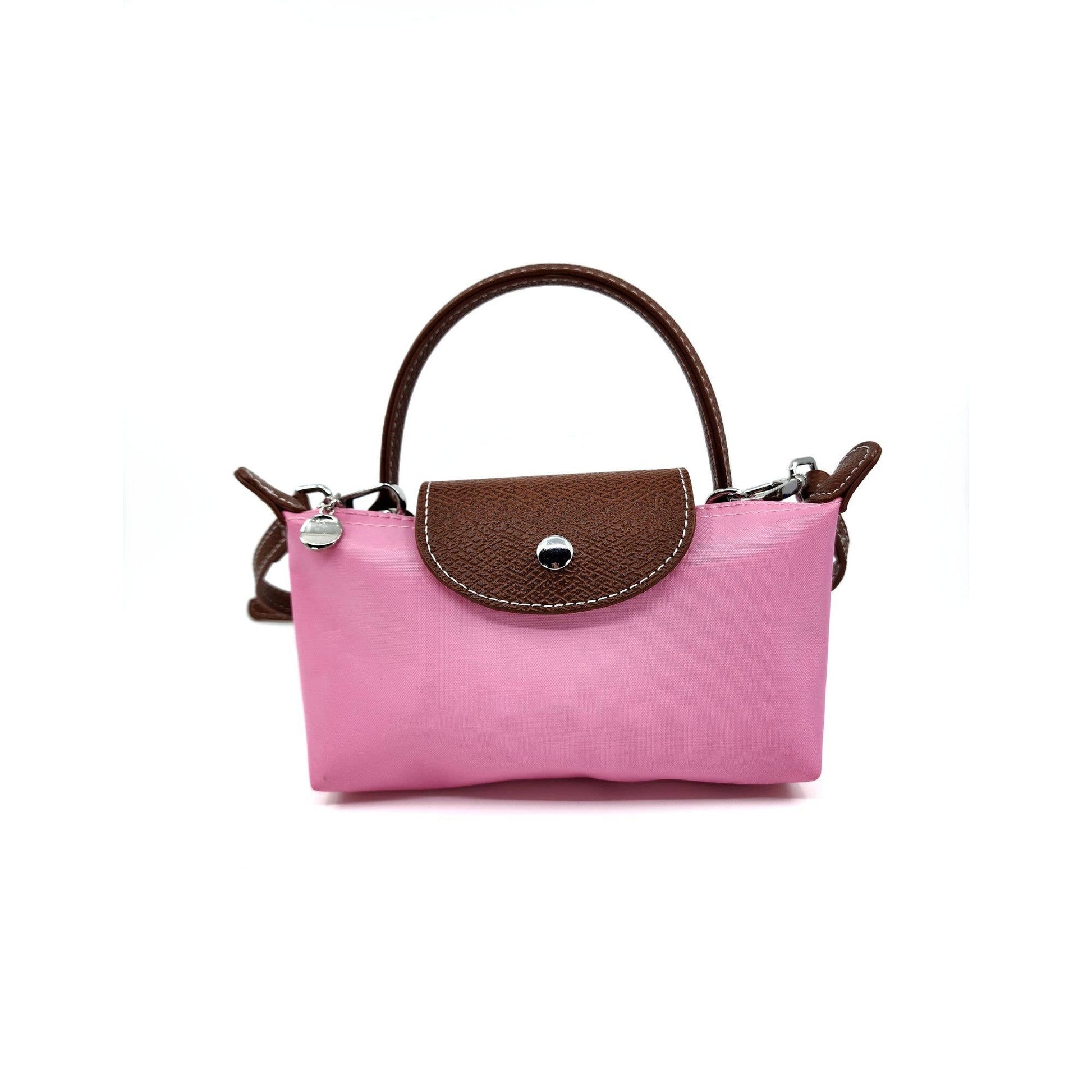 Pink handbag with brown top handle on a white background