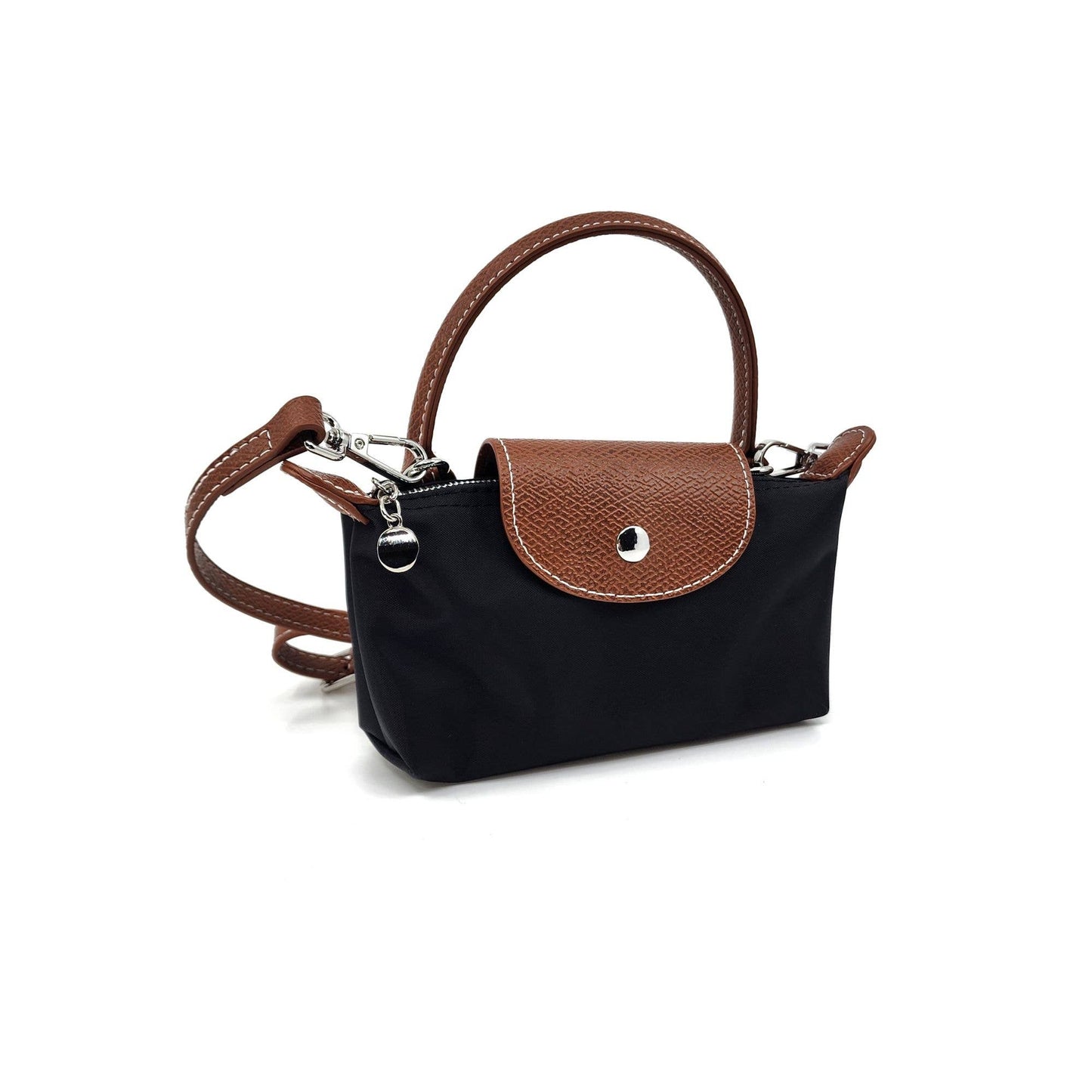 Black handbag with brown leather handle and strap on a white background